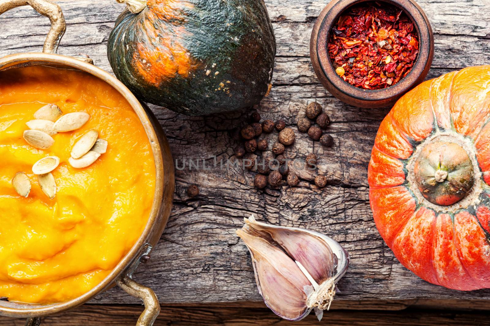 Pumpkin soup on a wooden table.Autumn pumpkin cream soup