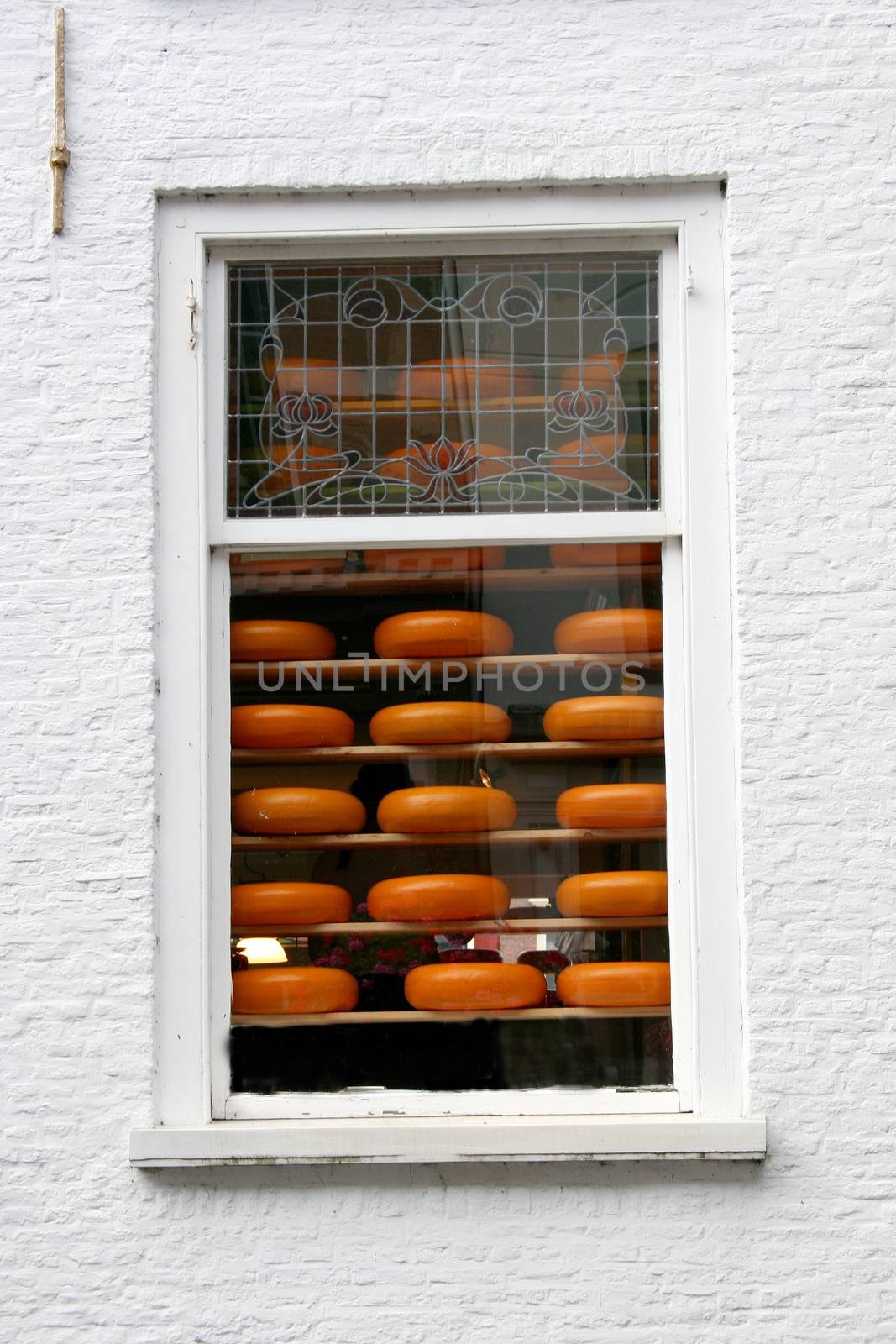 A window with cheeses for sale