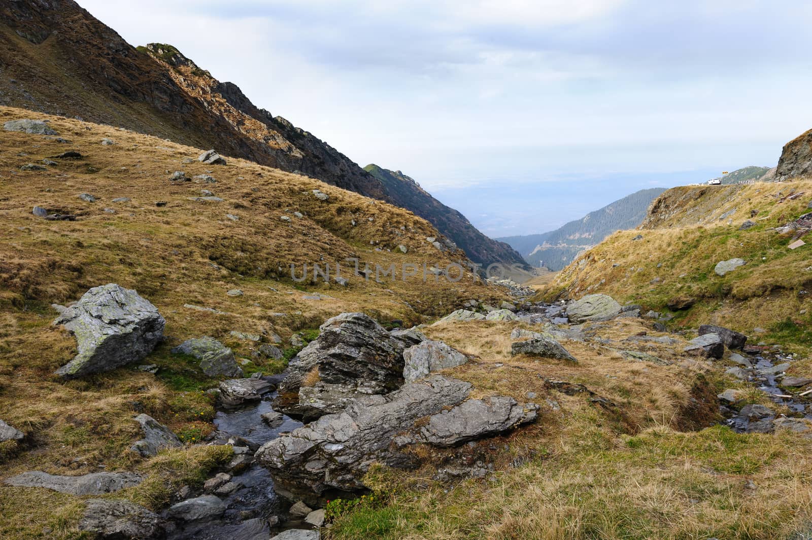 View from Transfagarasan road down to valley. It is a paved mountain road crossing the southern section of the Carpathian Mountains of Romania. It has national-road ranking and is the second-highest paved road in the country after the Transalpina.