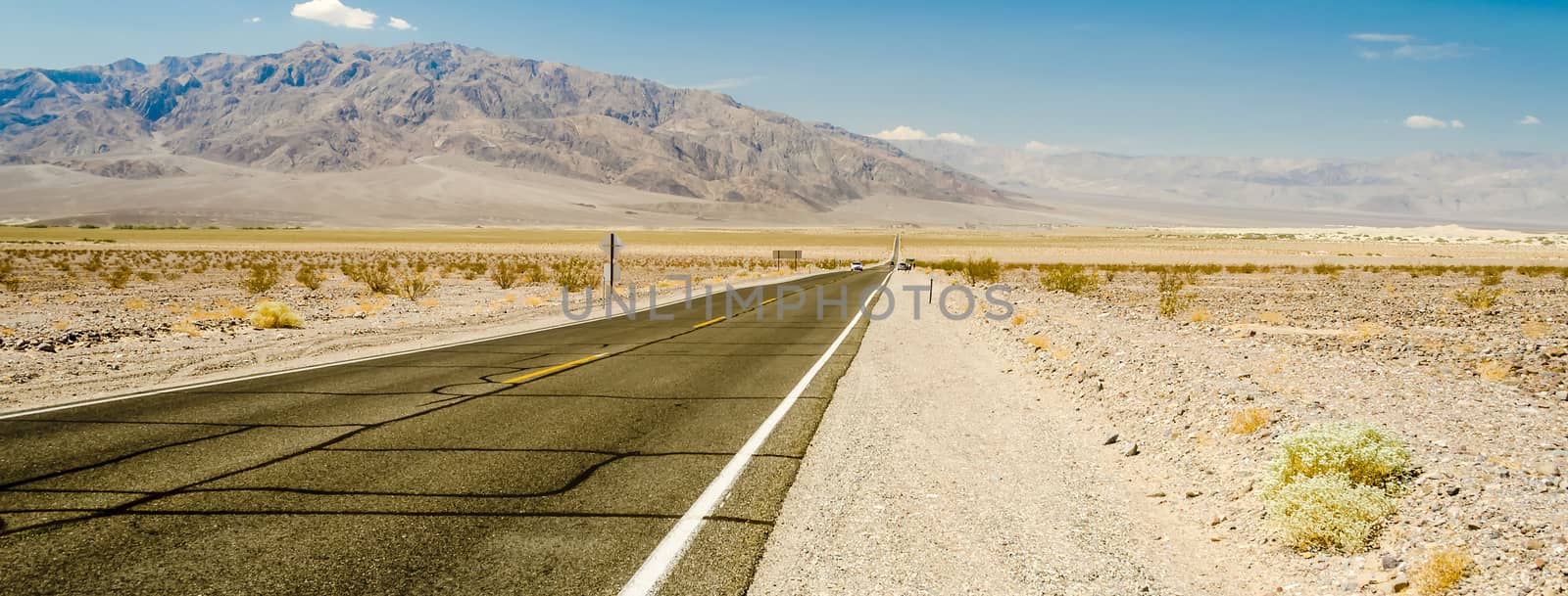 Hot desert road in Death Valley National Park, USA by marcorubino