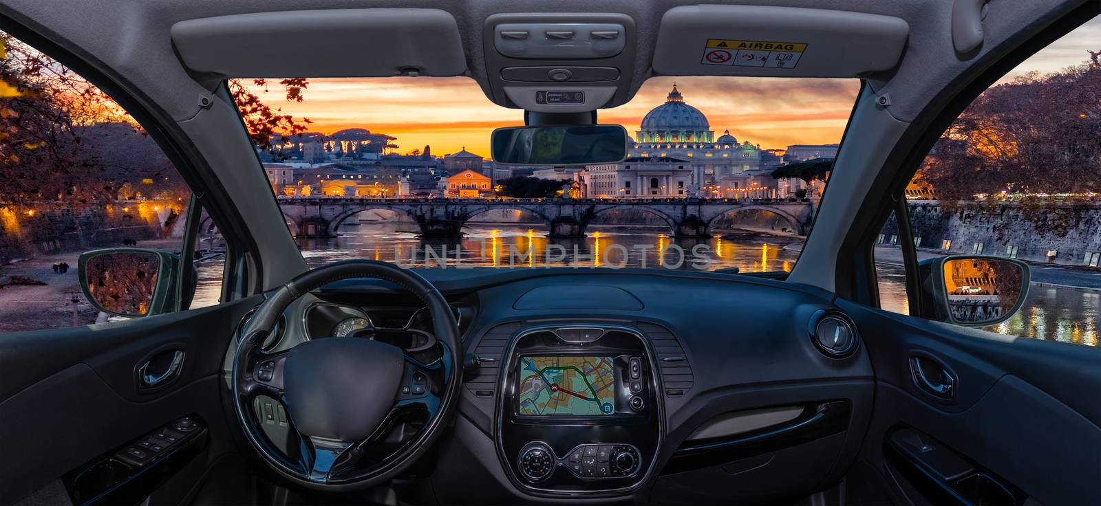 Looking through a car windshield with view over Saint Peter's Church during a wonderful sunset in Rome, Italy