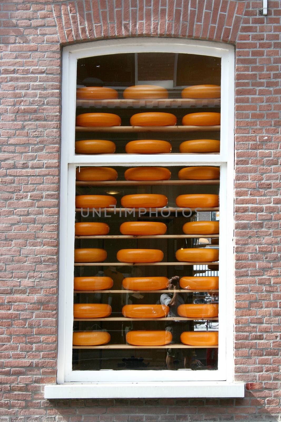 A window with cheeses for sale