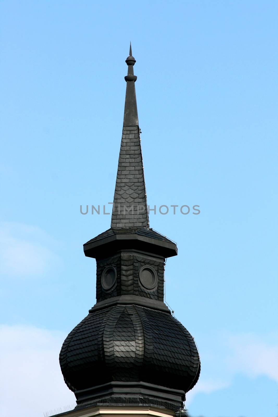 beautiful steeple, with a blue sky background 