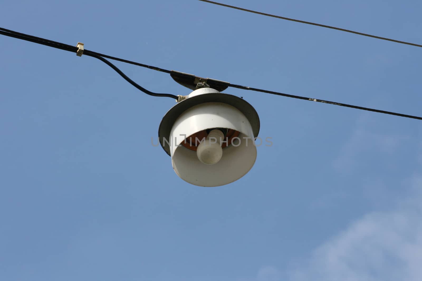 Street lamp on a steel cable suspended above the road,