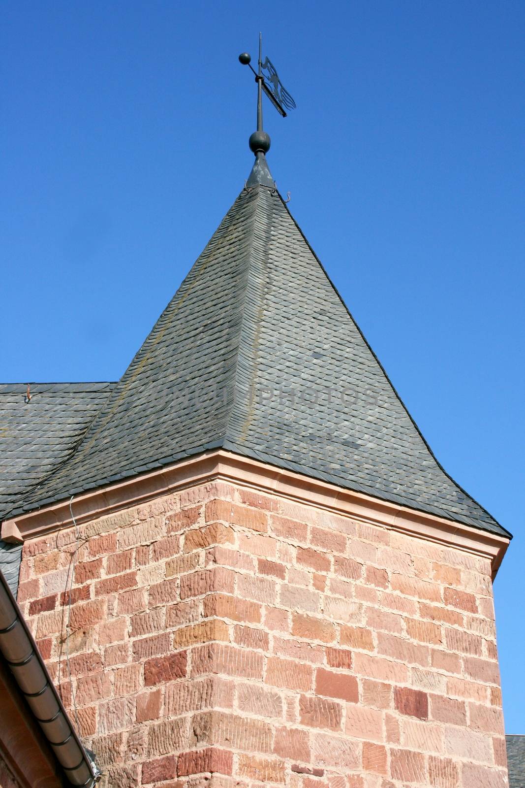 Detailed view of an imposing bell tower, blue sky in background