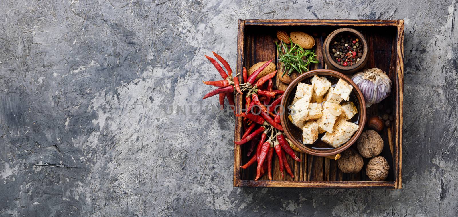 Feta cheese with herbs and garlic in bowl