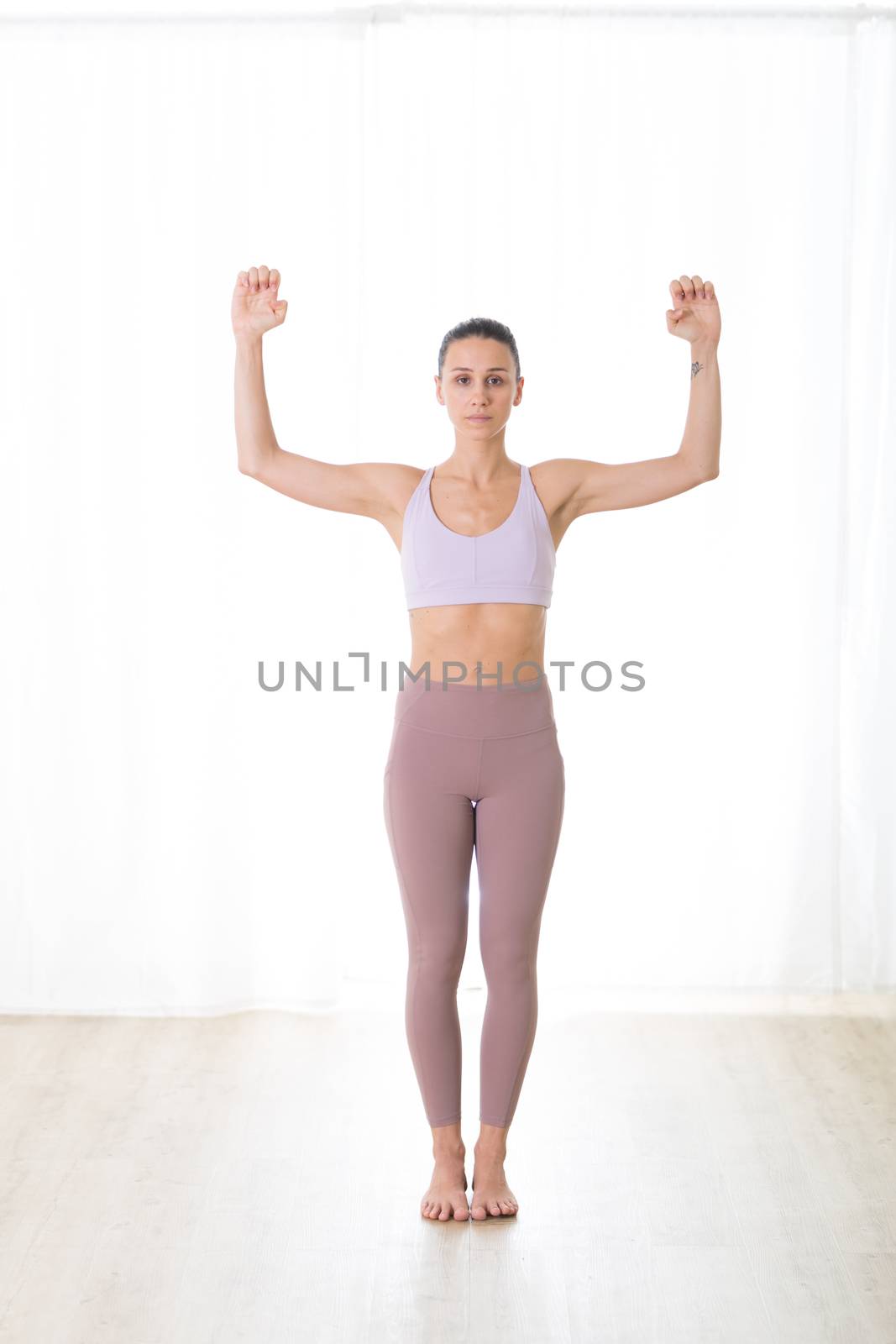 Portrait of gorgeous active sporty young woman practicing yoga in studio. Beautiful girl practice Pranayama breathing yoga pose. Healthy active lifestyle, working out in gym.