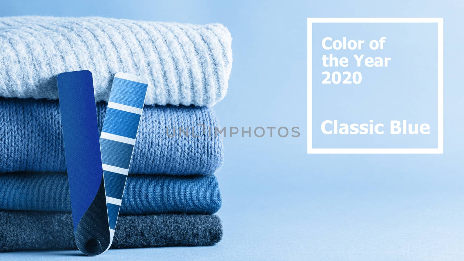 Stack of sweaters and color fun palette in classic blue 2020 color. Color of year 2020 concept for fashion and clothing industry. Banner