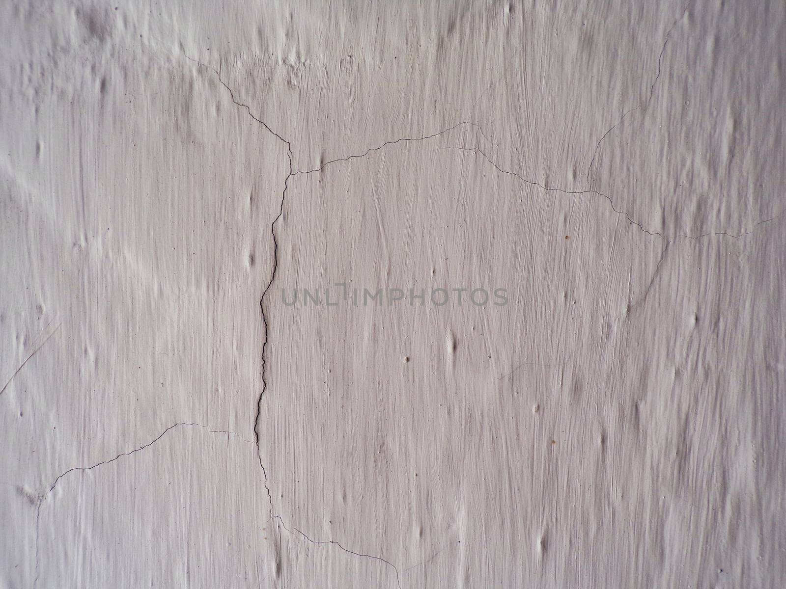 Background of an old whitewashed wall with a crack.