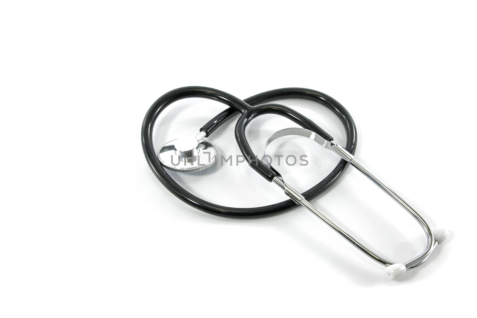 Stethoscope curved into the shape of a heart on white background