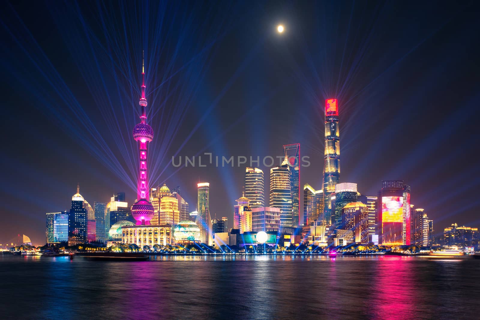 laser show over illuminated Lujiazui skyline and Huangpu river at night, Shanghai, China