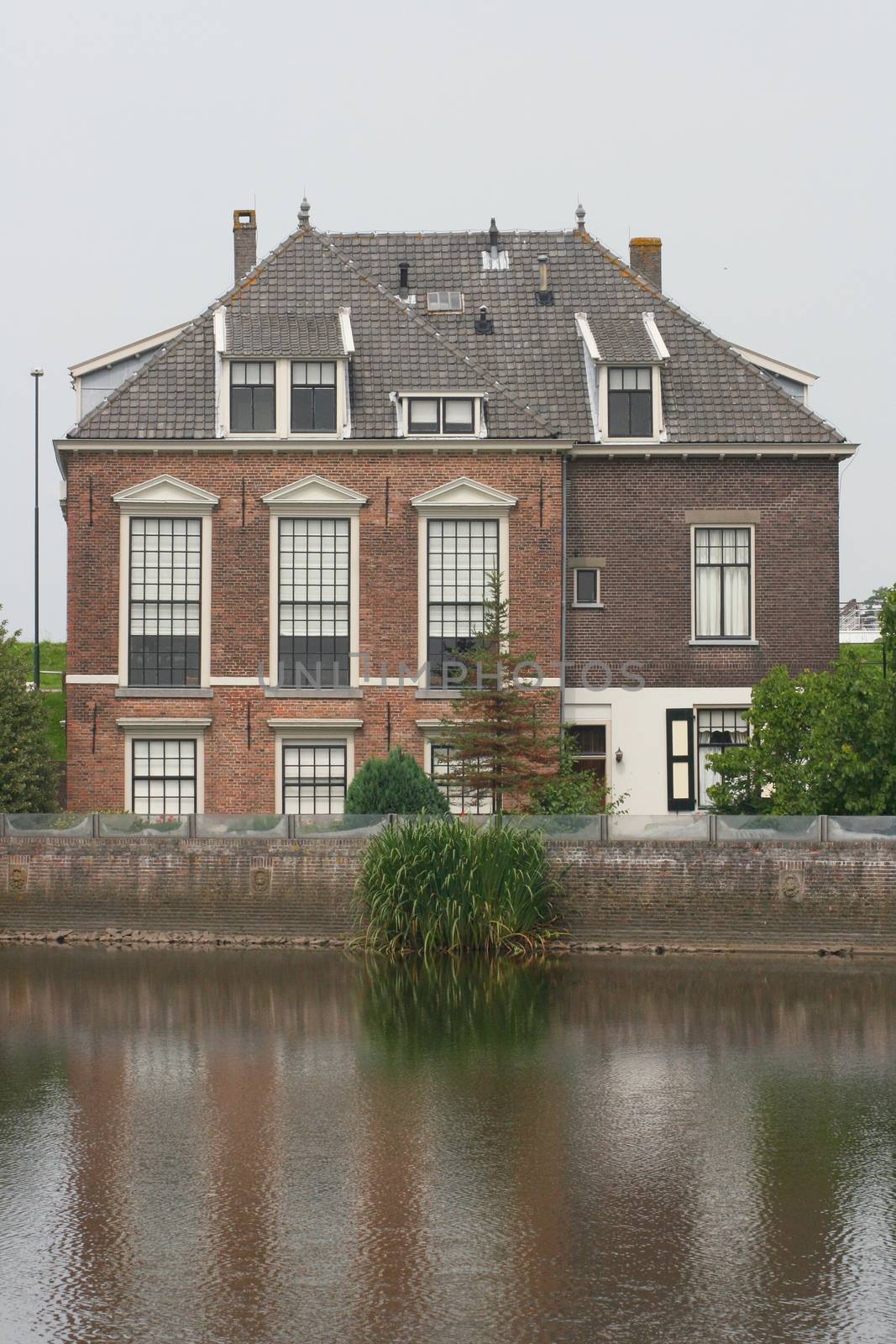 Lonely old House, with a body of water in the foreground