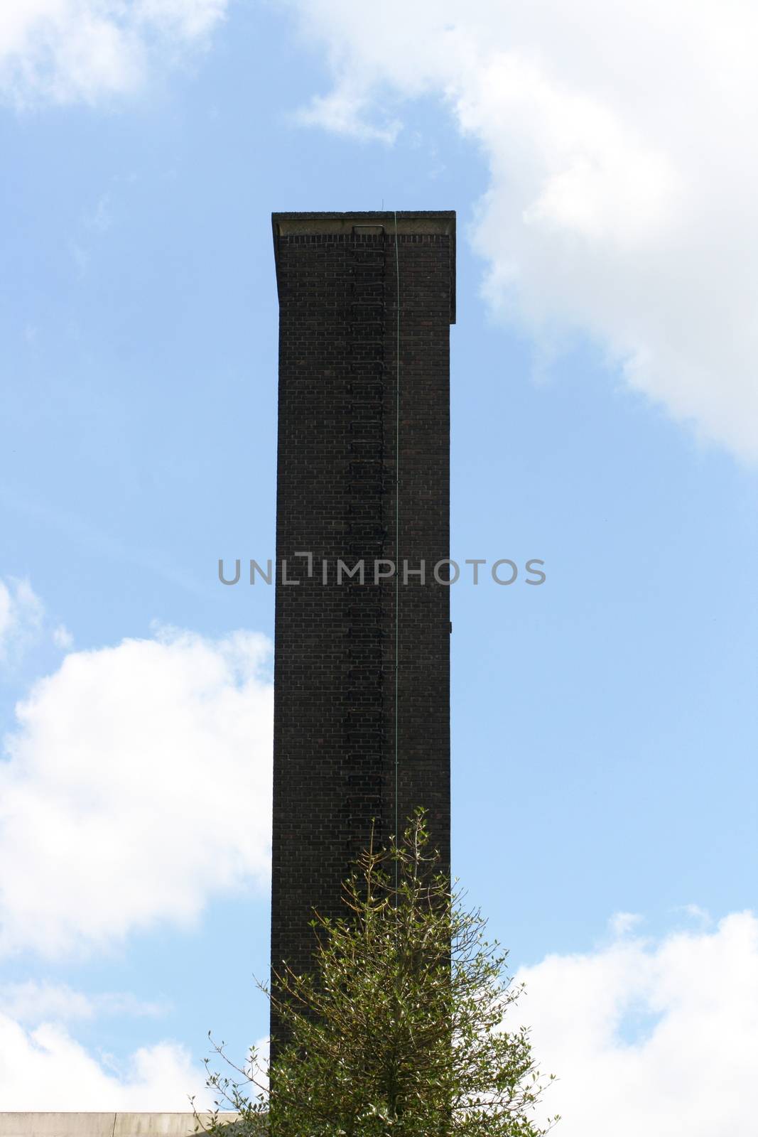 A high chimney masonry with black bricks