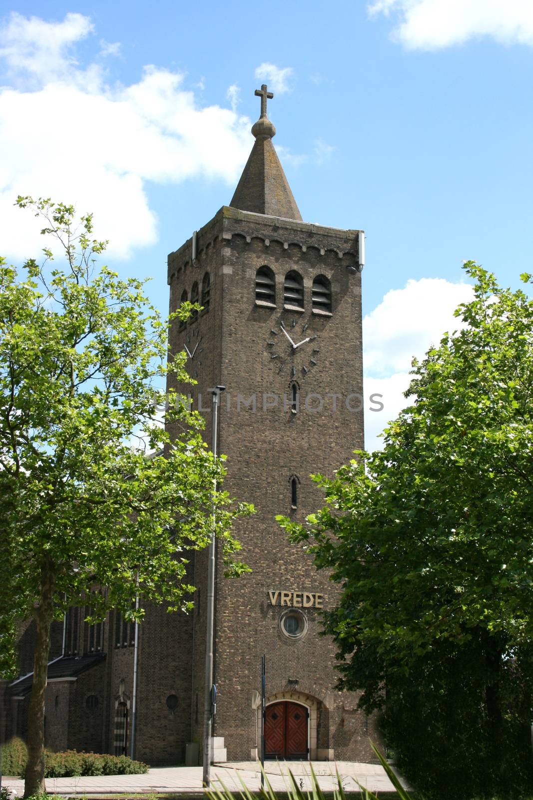 Imposing church tower with blue sky in the background