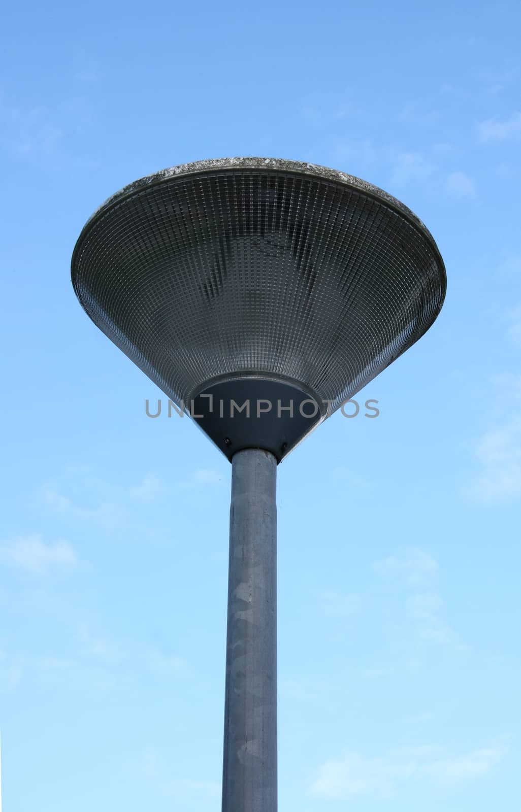 Street lamp with a large screen, blue sky in the background 