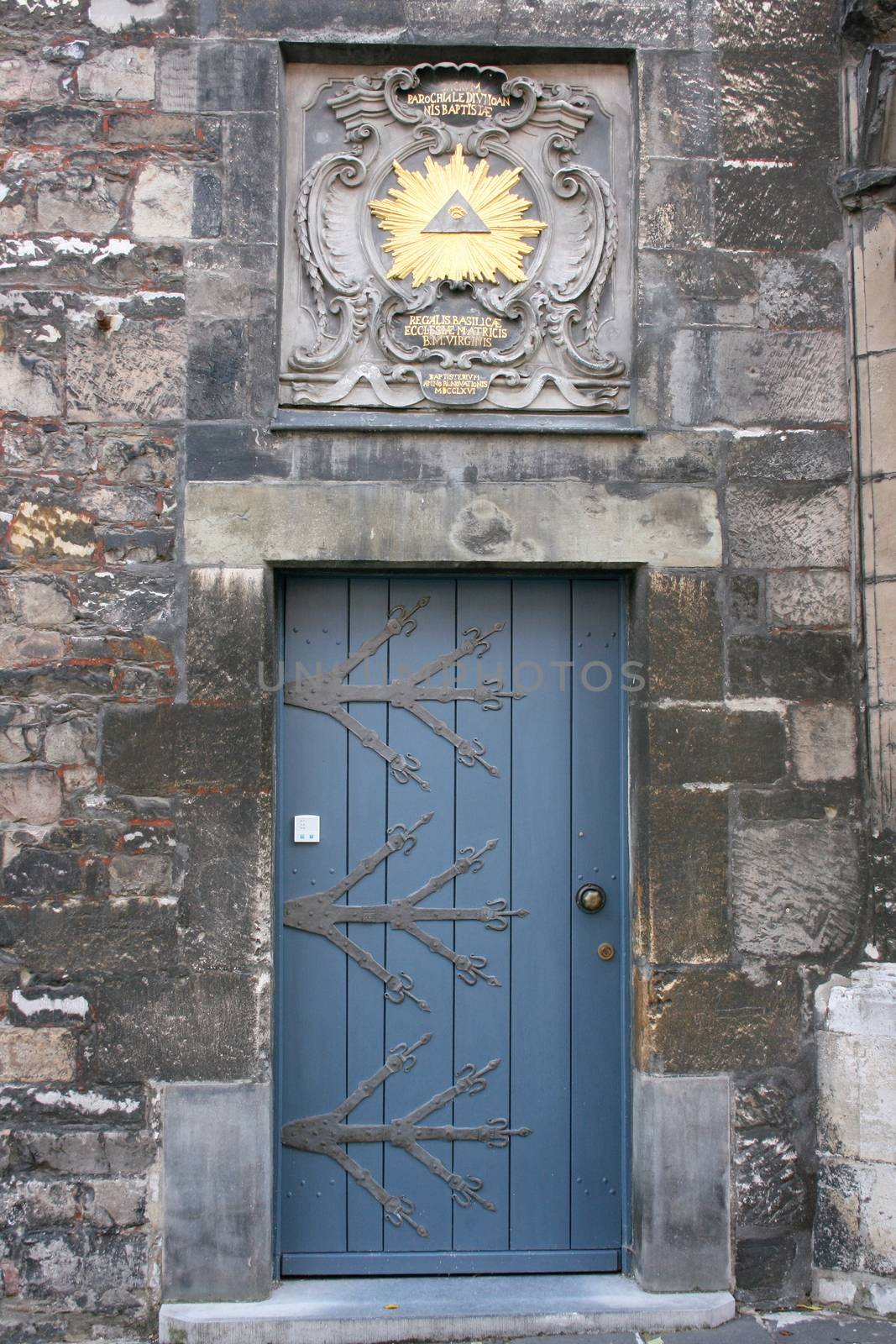 Blue wooden door, with large wrought-iron hinges
