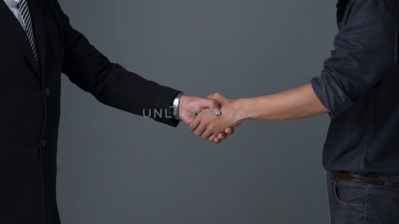 Image businessman handshake , Hand holding on gray background