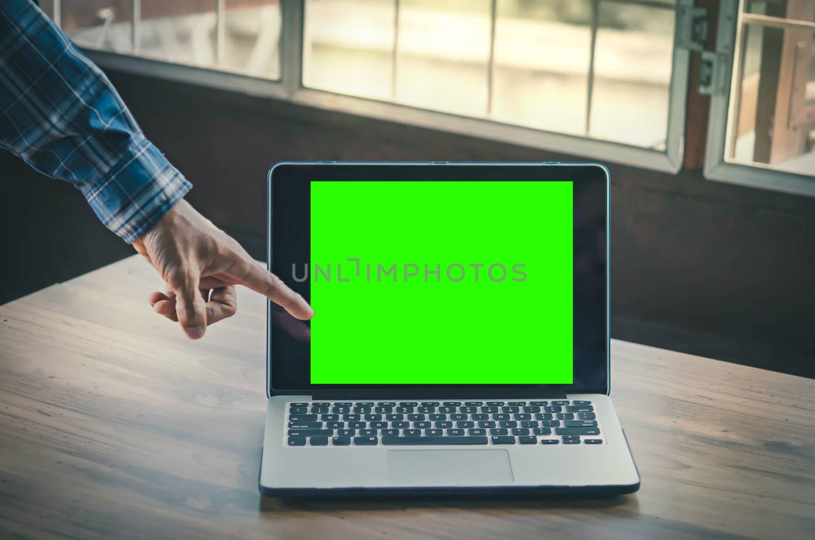 Workplace with notebook laptop Comfortable work table in office windows with greenscreen