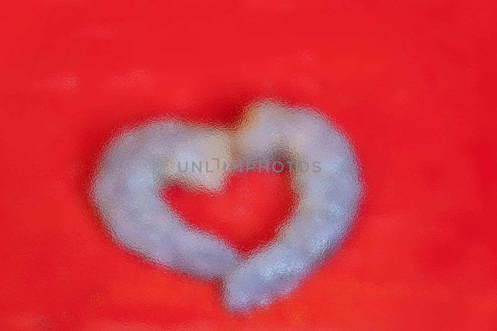 The blur focus of heart shape on red background, valentine concept