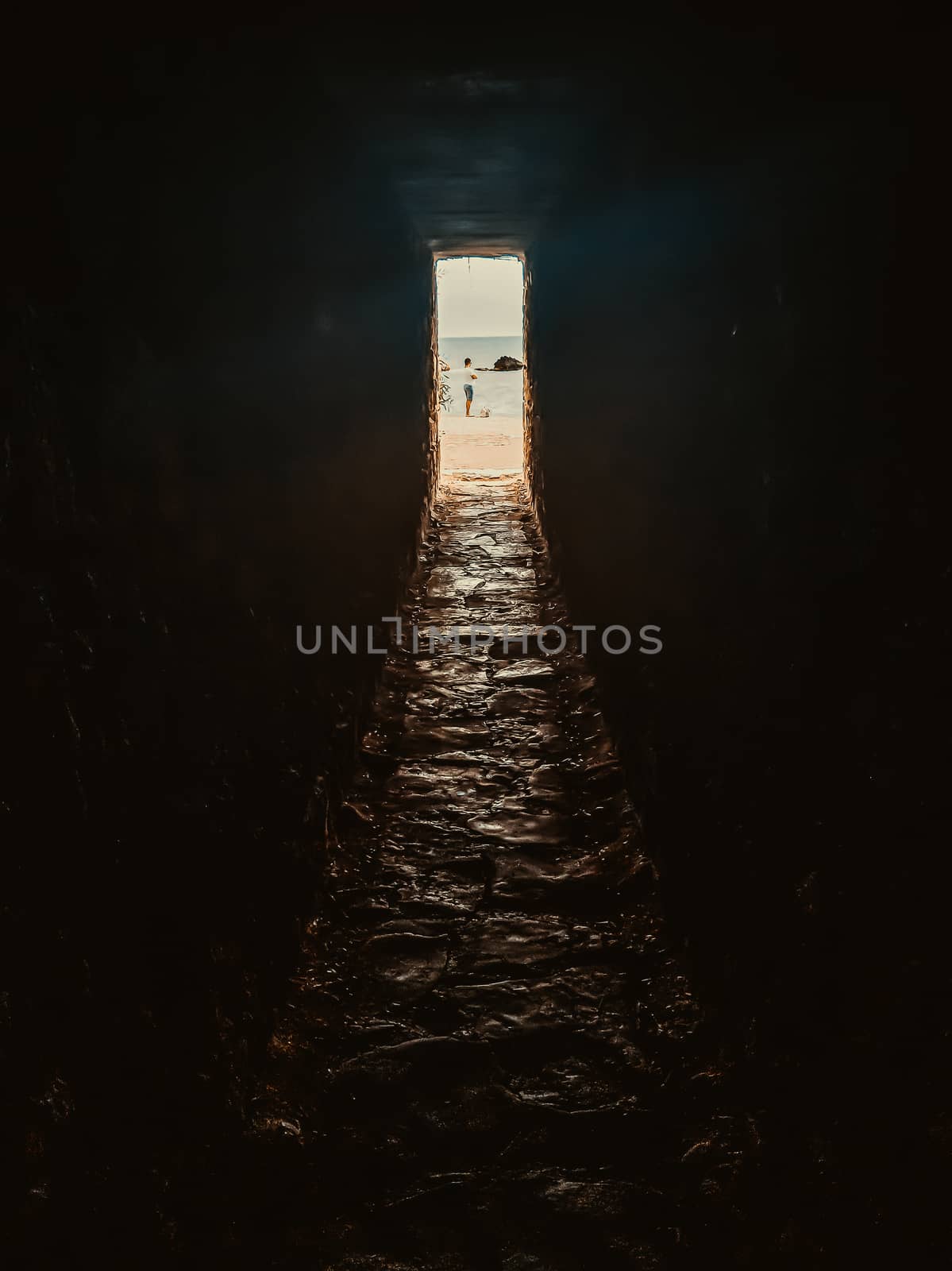 Light and exit in the end of dark long tunnel or corridor, way to freedom concept. Industrial round chalk mine passage With hole, perspective, toned