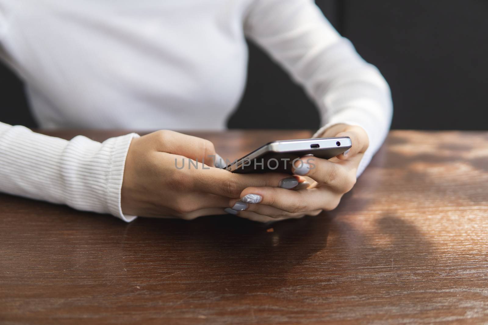 Beautiful young woman's hand using smart phone