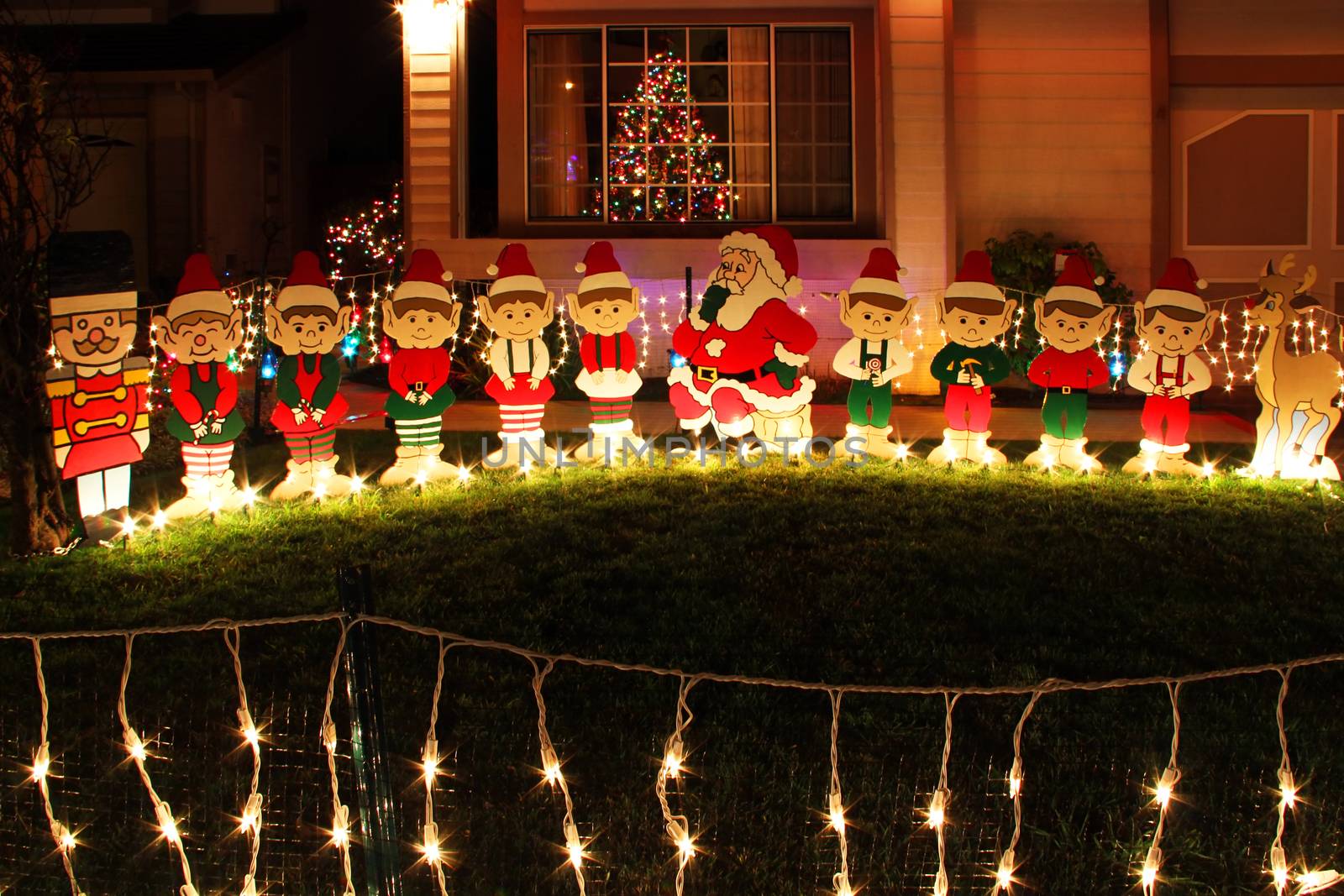 Decorative Christmas ornaments in the garden against the background of the house