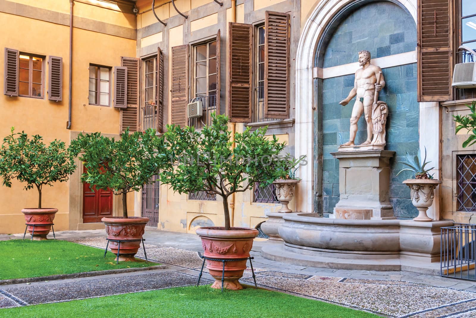 Outer courtyard of the Medici Riccardi Palace, which has an Italian garden with statues and tubs with plants. Florence, Italy