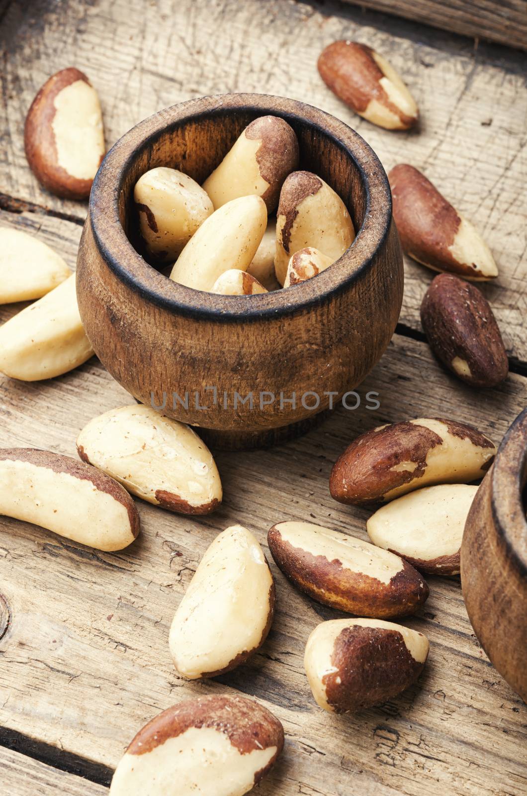 Wooden retro mortar filled with Brazil nut