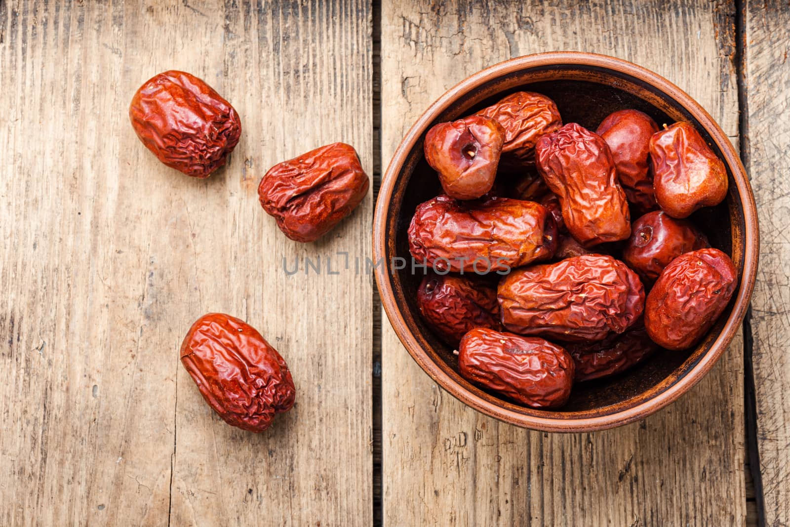 Bowl of dried unabi fruit or jujube.Space for text