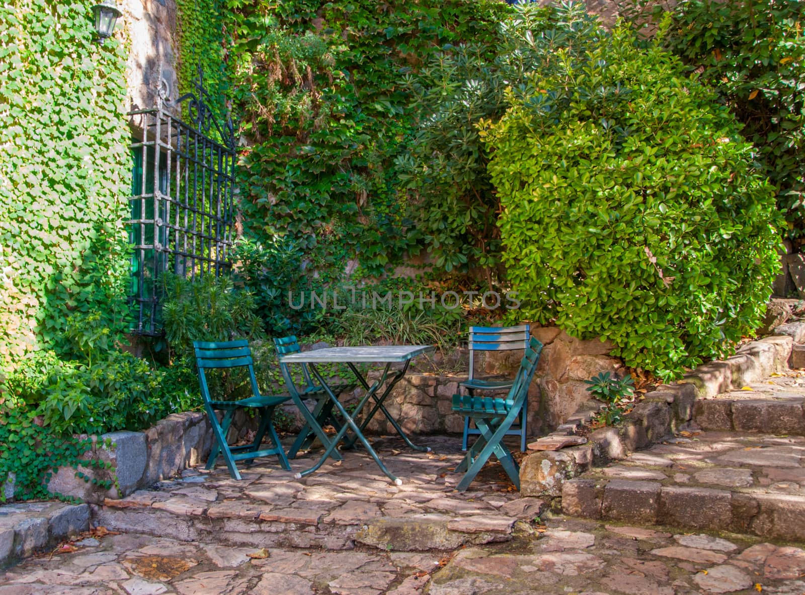 Spain, Tossa de Mar, cobbled street, staircase and stone wall in medieval Old Town.