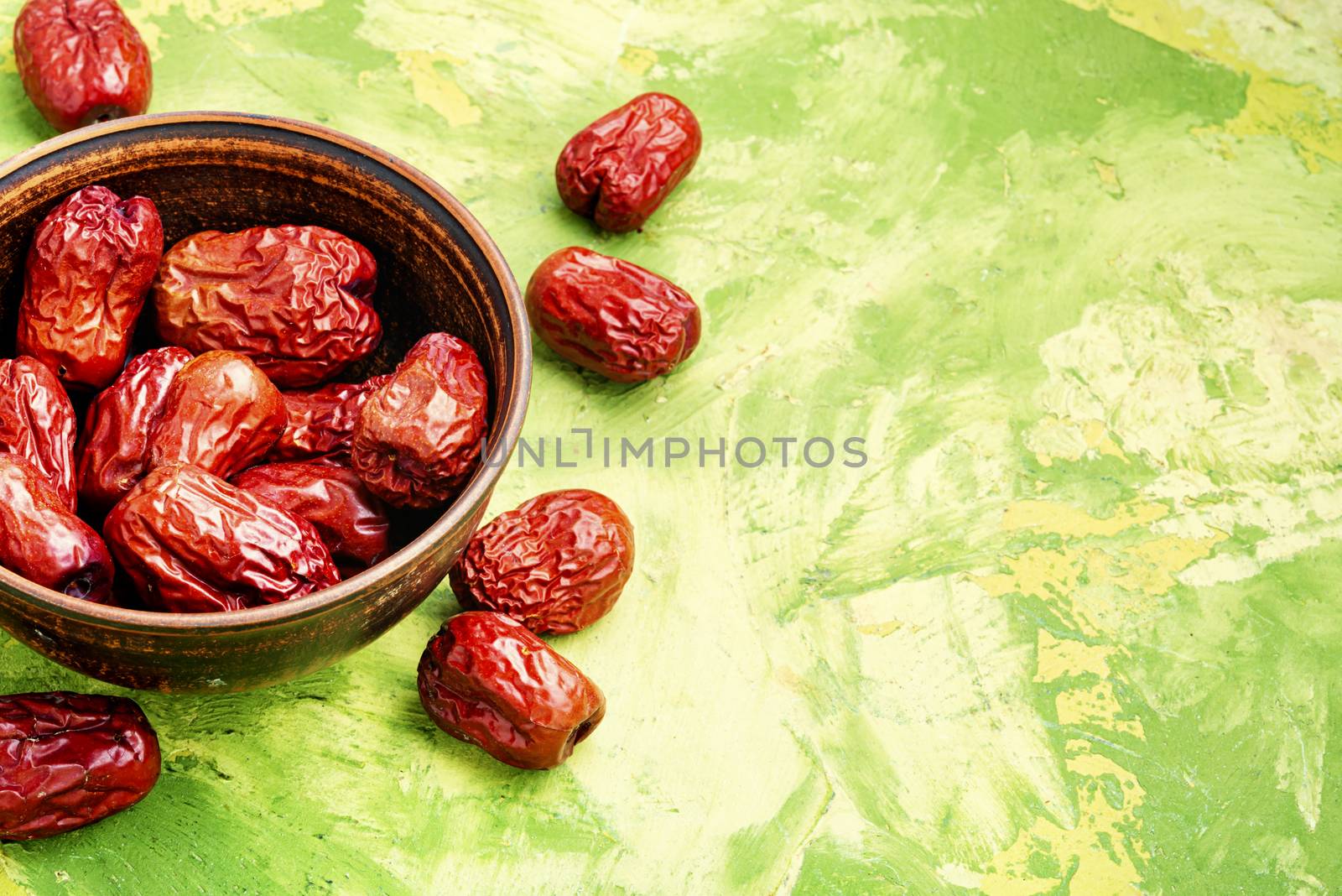 Bowl of dried unabi fruit or jujube.Space for text