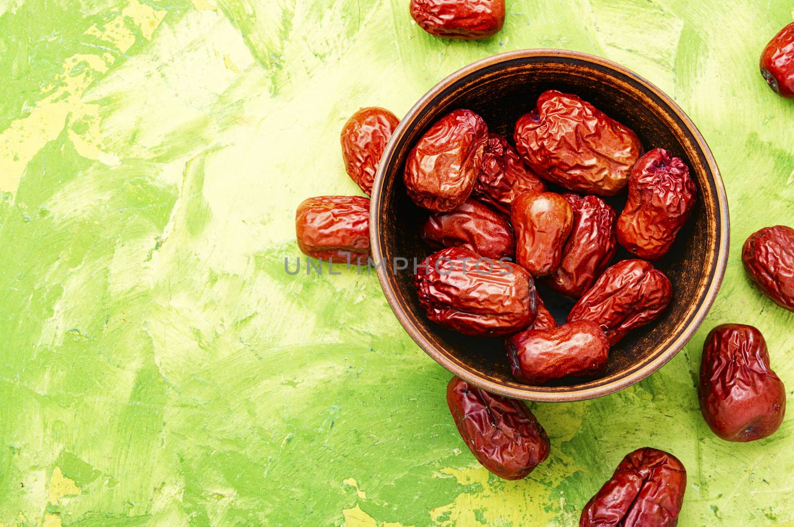 Bowl of dried unabi fruit or jujube.Space for text