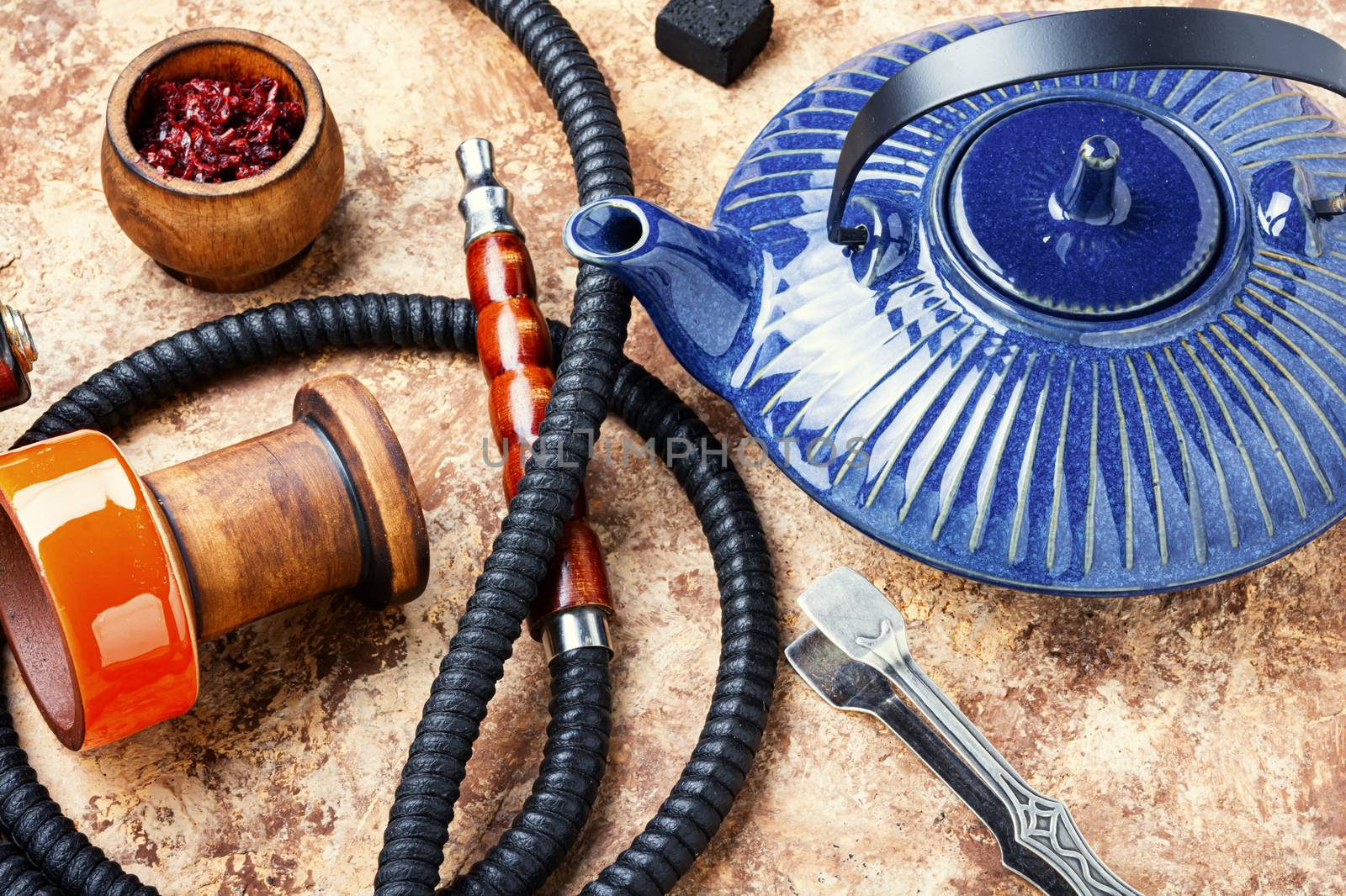 Details of tobacco hookah and teapot with tea.Eastern smoking shisha