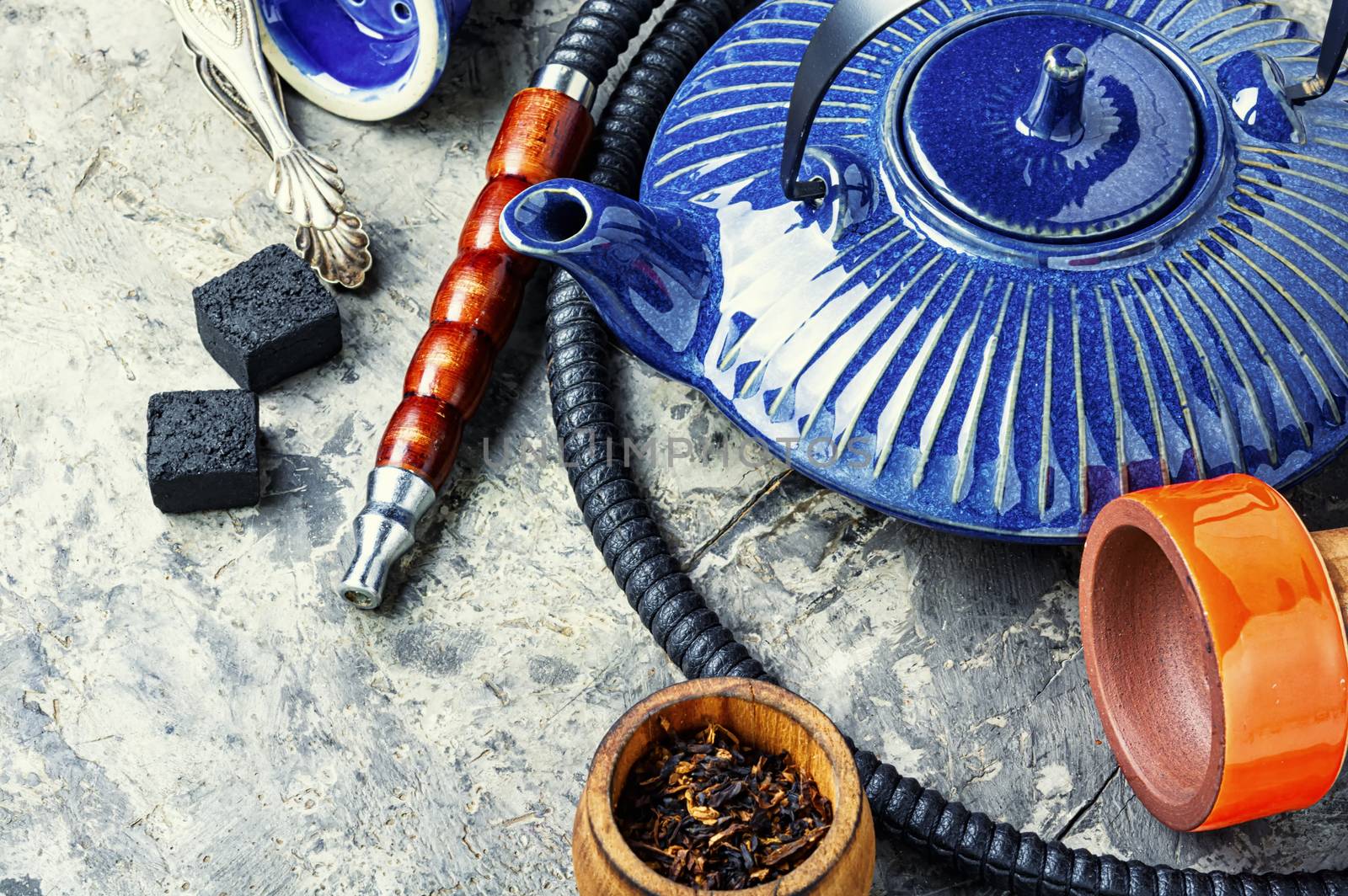 Details of tobacco hookah and teapot with tea.Egyptian smoking shisha and teakettle