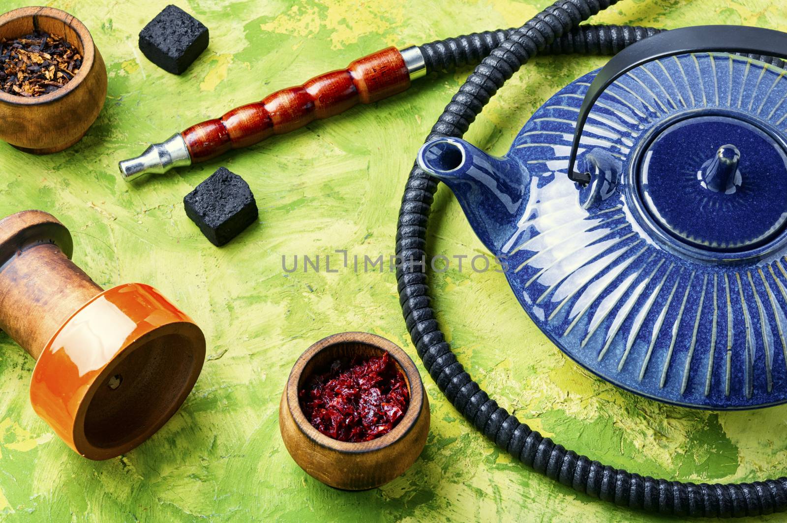 Details of tobacco hookah and teapot with tea.Egyptian smoking shisha and teakettle