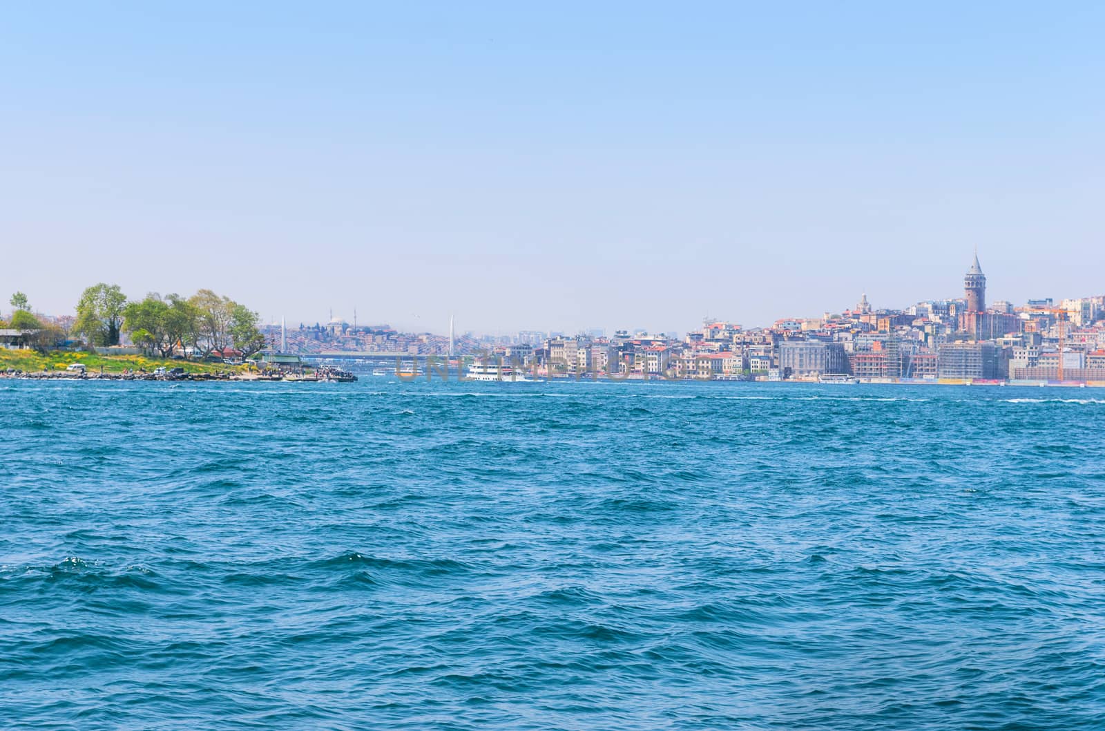 View from the water on the historical center of Istanbul. View of the Galata bridge, Eminonu district and square and Balik Ekmek boat shops.