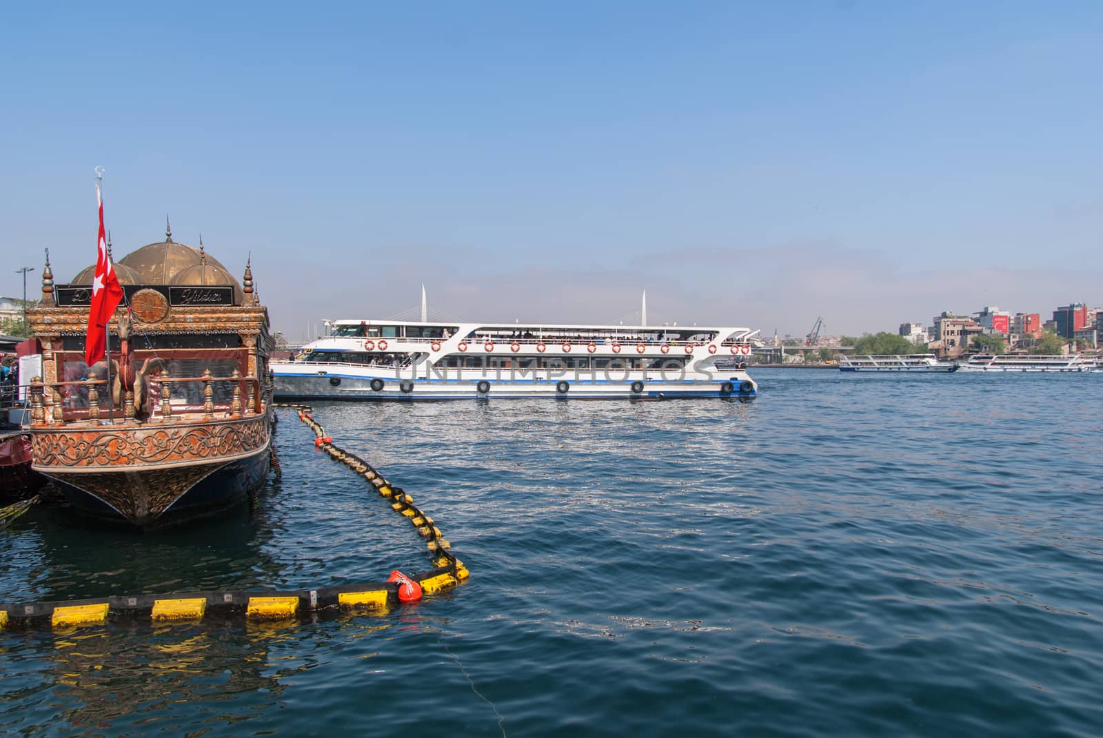 Istanbul, Turkey -May 1,2018 .amateur fisher on pier and city lines ferry carrying passengers to asia from europe in istanbul