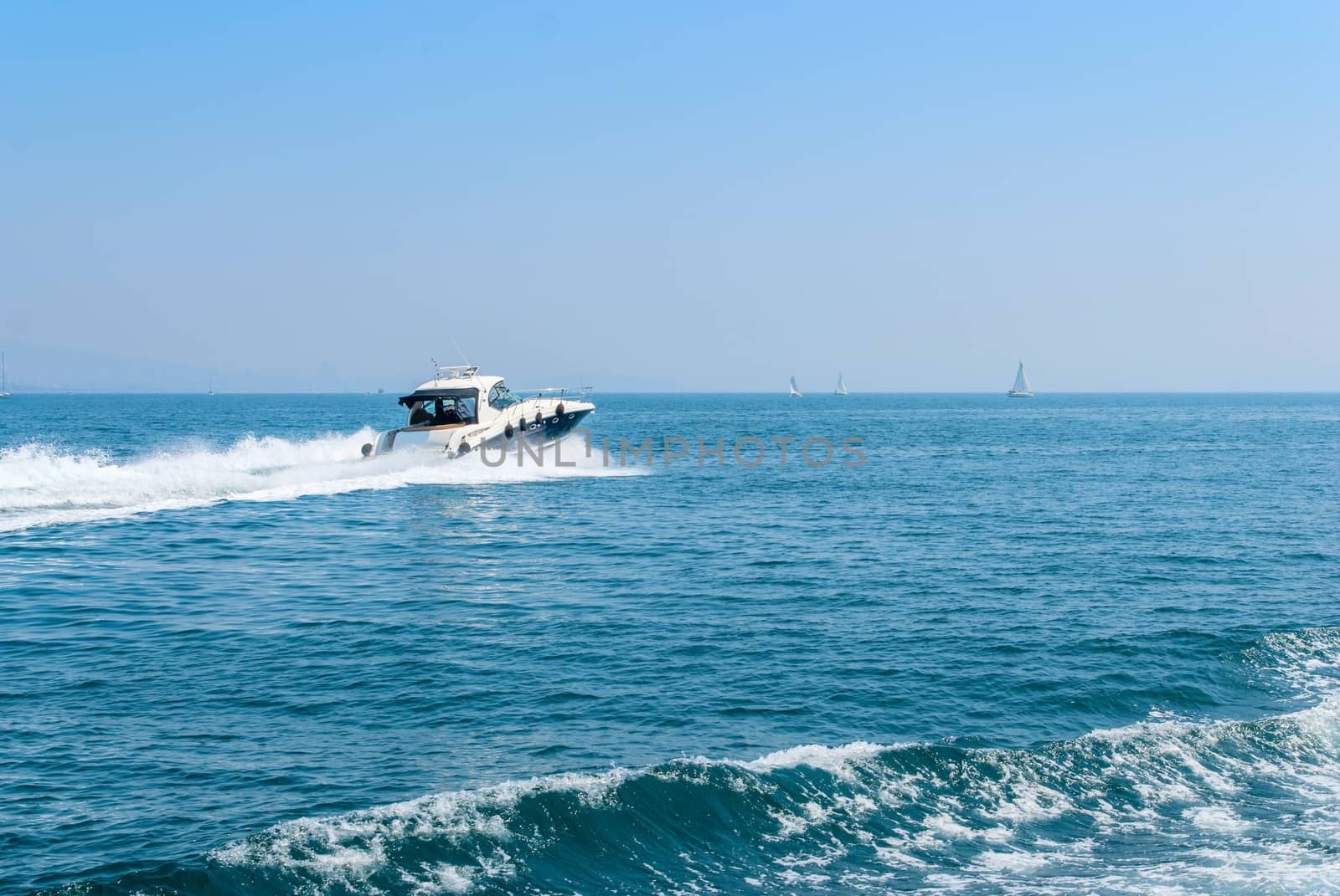 Large private motor yacht out on sea on blue sky background. Vacation holiday concept.