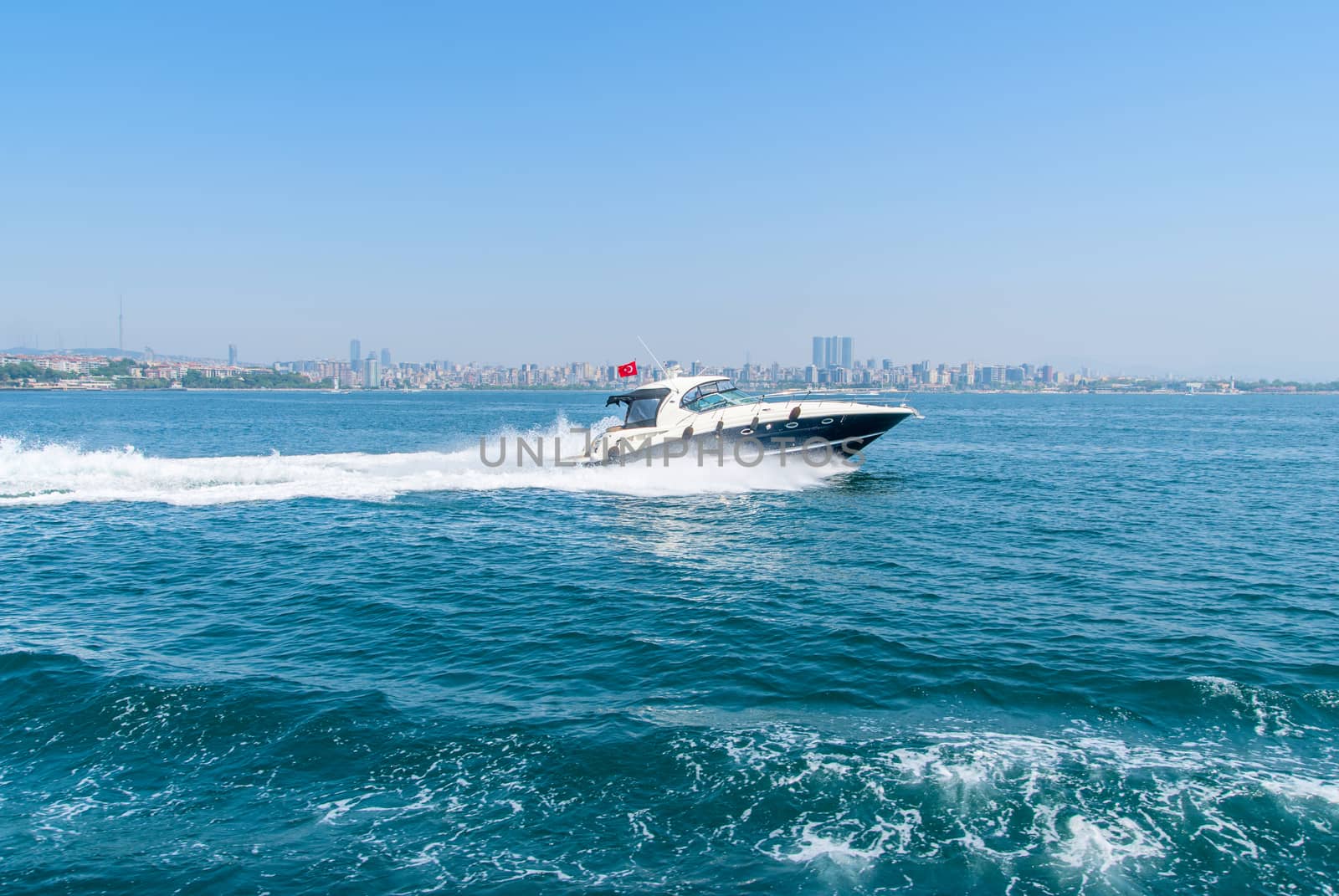 Tourist passenger motor boat on the Bosphorus strait, Sea front landscape of Istanbul historical part, Turkey famous city.