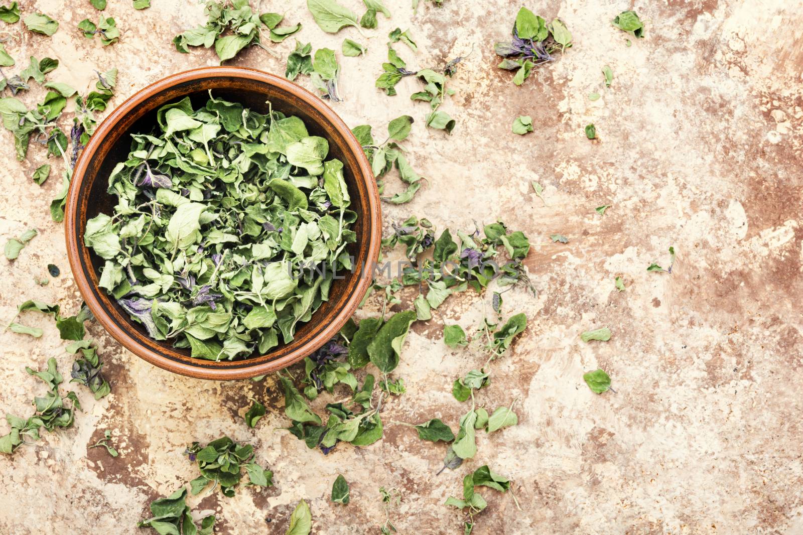 Bowl of dried oregano leaves.Dried oregano seasoning.Space for text