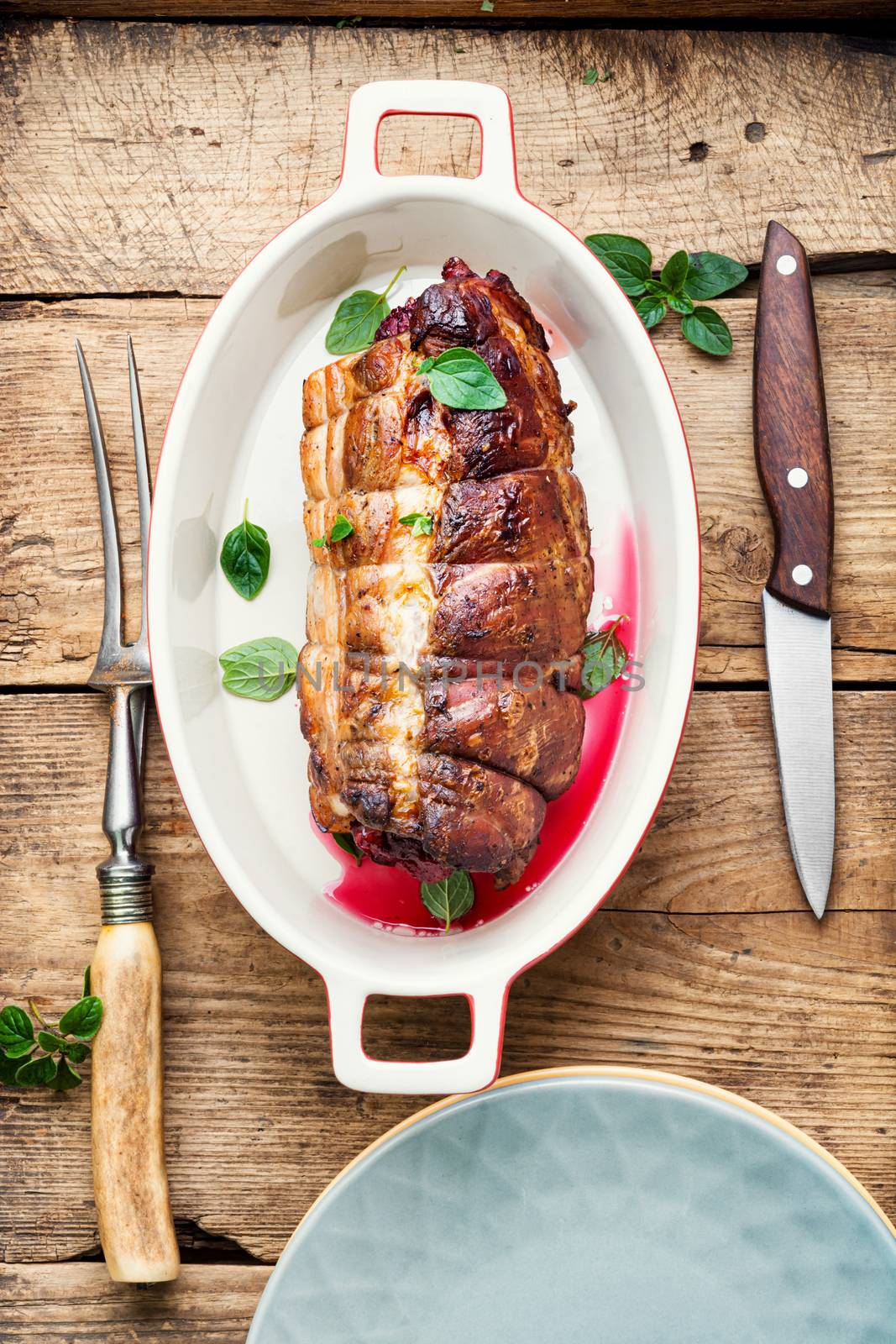 Roasted pork with cherry filling.Baked pork in a baking dish
