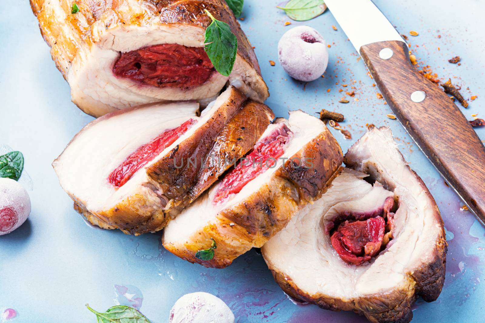 Roasted pork with cherry filling on plate.Baked pork,closeup