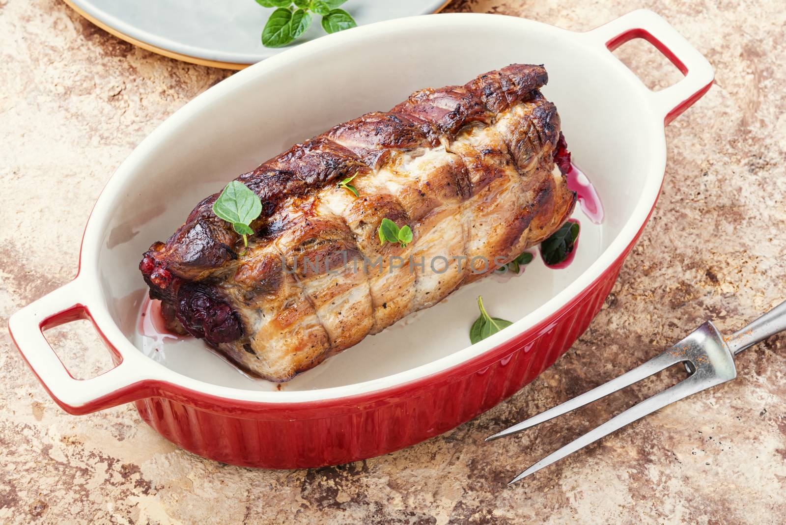 Baked pork meat stuffed with cherries.Baked pork.