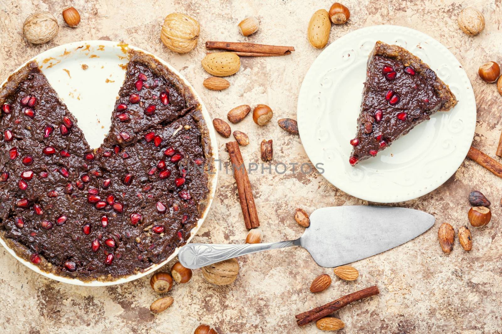 Tasty homemade chocolate cake with pomegranate and nut.