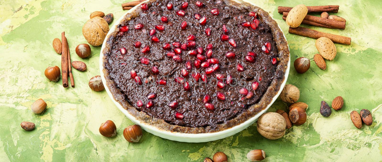 Delicious chocolate cake with pomegranate and nut.Chocolate brownie cake