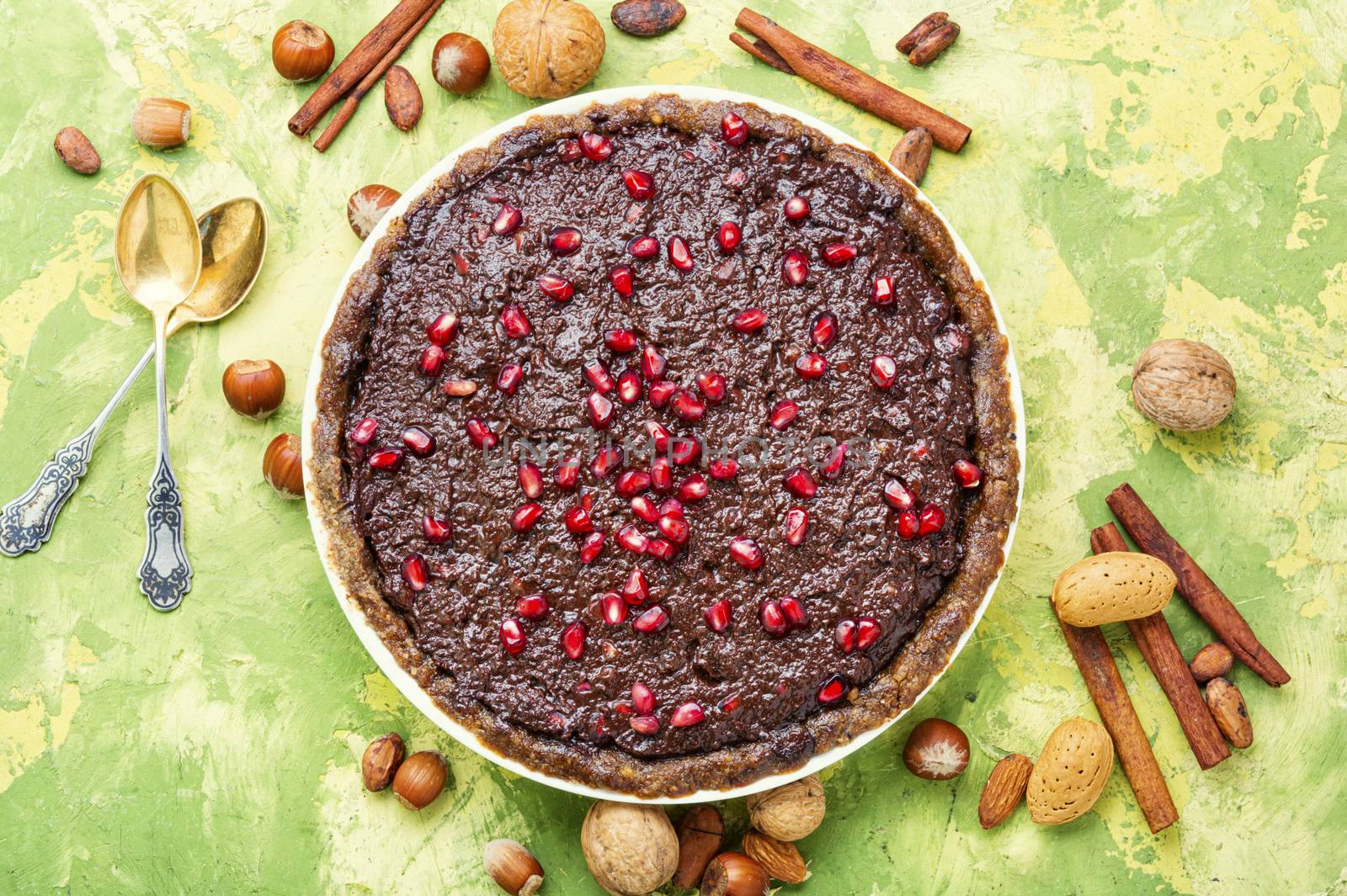 Delicious chocolate cake with pomegranate and nut.Chocolate brownie cake