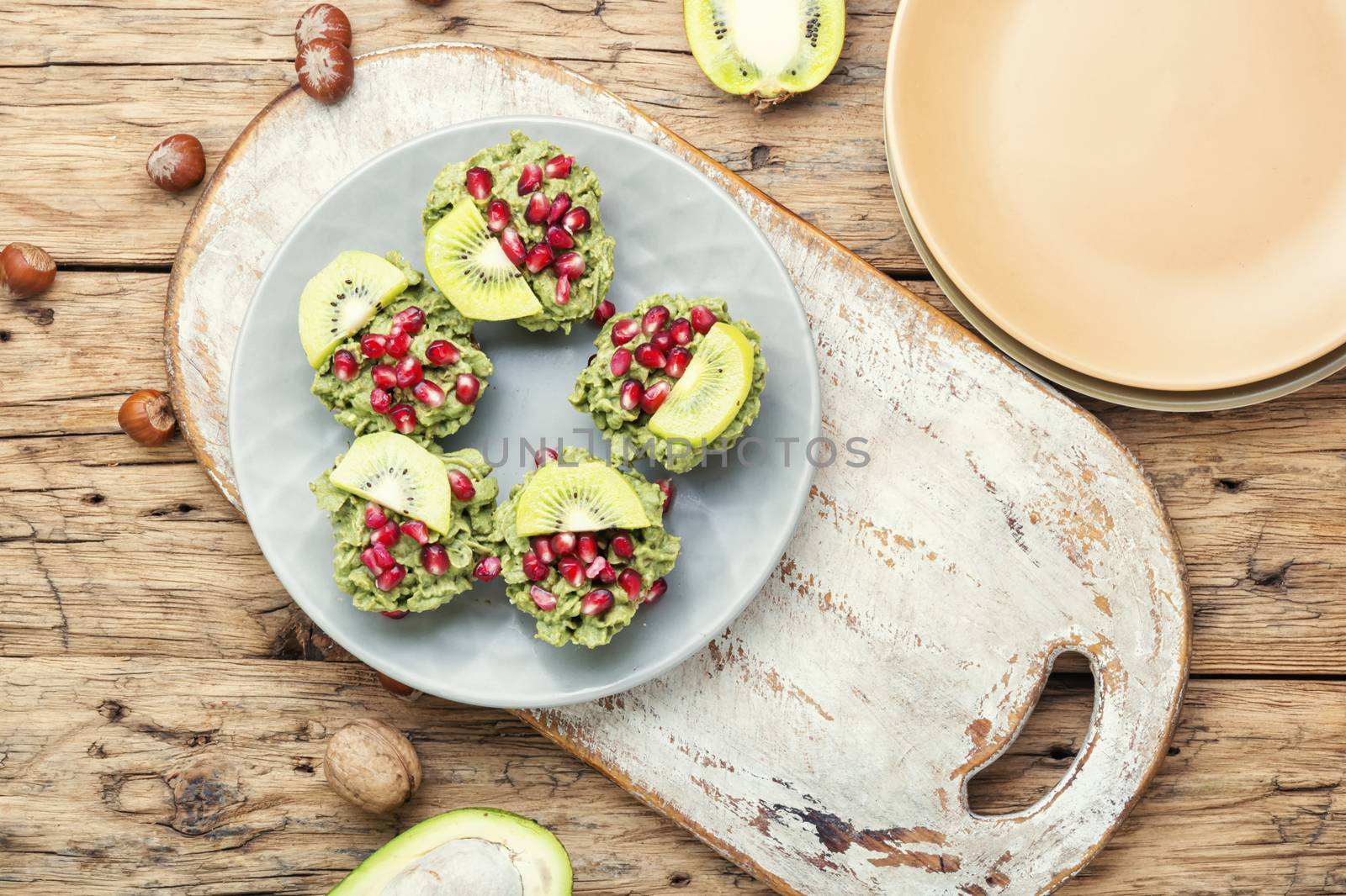 Diet avocado cupcakes garnished with kiwi and pomegranate