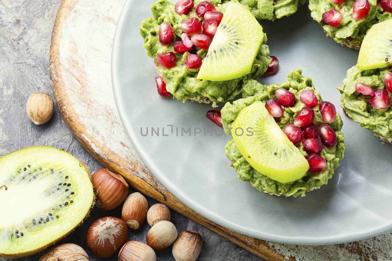 Avocado cupcakes or muffin garnished with kiwi and pomegranate.Cupcakes, close-up.