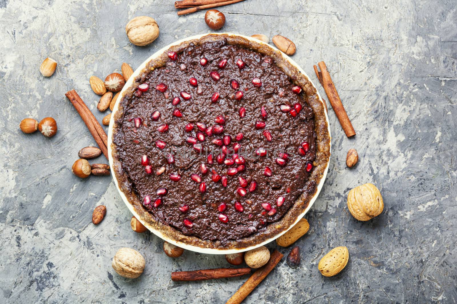 Chocolate cake with pomegranate and nut.Chocolate brownie cake