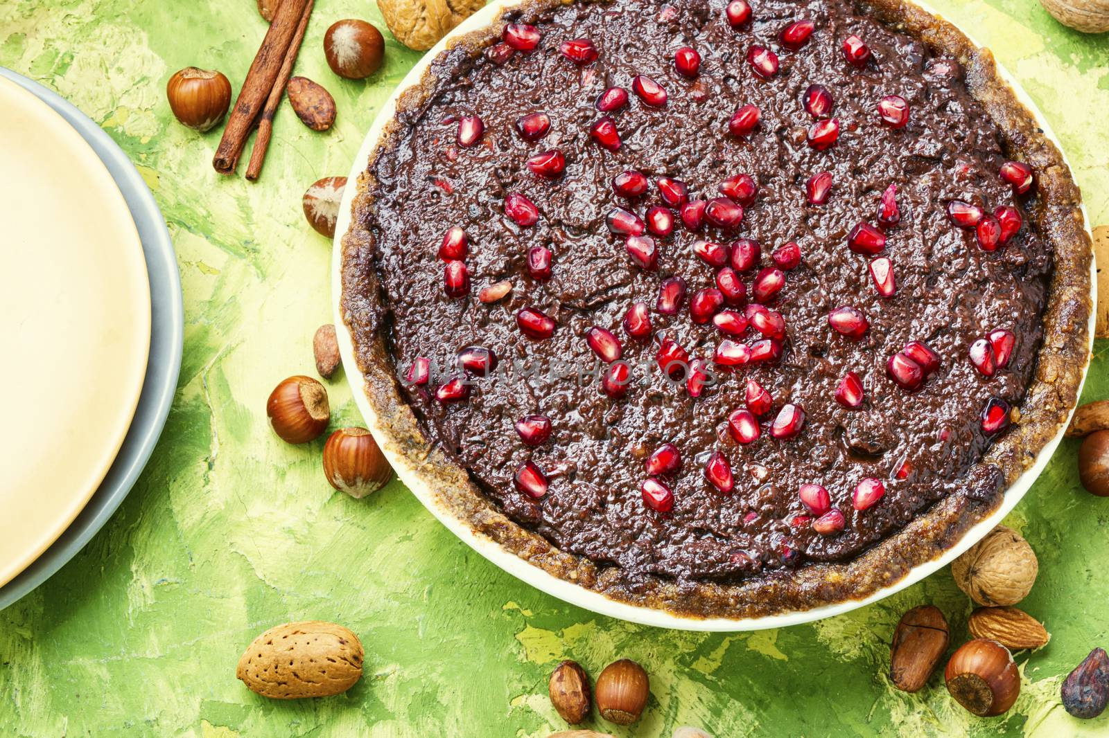 Delicious chocolate cake with pomegranate and nut.Chocolate brownie cake